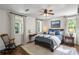 Bright bedroom with wood floors, ceiling fan, and ample natural light offers a cozy ambiance at 3415 Habersham Nw Rd, Atlanta, GA 30305