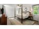 Spacious bedroom with a four-poster bed, ceiling fan, and plenty of natural light at 3415 Habersham Nw Rd, Atlanta, GA 30305