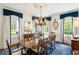 Formal dining room with large windows, wooden table, and chandelier at 3415 Habersham Nw Rd, Atlanta, GA 30305