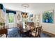 Elegant dining room with large table, chandelier, and blue accents at 3415 Habersham Nw Rd, Atlanta, GA 30305