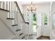 Bright entryway with staircase featuring hardwood floors and a chandelier at 3415 Habersham Nw Rd, Atlanta, GA 30305