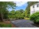 Wide driveway with fence surrounding backyard in this charming two-story home at 3415 Habersham Nw Rd, Atlanta, GA 30305