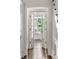 Hallway view to a sunlit seating nook with french doors in a bright and airy home at 3415 Habersham Nw Rd, Atlanta, GA 30305