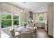 Bright kitchen nook boasts an elegant chandelier and scenic views through large windows at 3415 Habersham Nw Rd, Atlanta, GA 30305