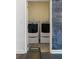 Convenient laundry room features a bench and side-by-side washer and dryer at 3415 Habersham Nw Rd, Atlanta, GA 30305