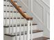 Classic staircase features a wooden handrail, white risers, and paneled walls at 3415 Habersham Nw Rd, Atlanta, GA 30305