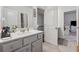 Well-lit bathroom with a vanity, mirror, tile floors, and neutral color scheme at 3711 Wartrace Dr, Atlanta, GA 30331