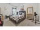 Calm bedroom featuring a comfortable bed, dresser with mirror, and a cozy chaise lounge at 3711 Wartrace Dr, Atlanta, GA 30331