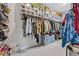 Walk-in closet equipped with ample shelving, rods and clear shoe boxes at 3711 Wartrace Dr, Atlanta, GA 30331
