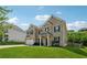 Lovely exterior of two-story home featuring a green lawn, attached garage, and brick facade at 3711 Wartrace Dr, Atlanta, GA 30331