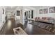 Open-concept living room featuring hardwood floors, modern furniture, and seamless flow to kitchen at 3711 Wartrace Dr, Atlanta, GA 30331