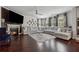Bright living room with fireplace, ceiling fan, large couch, and dark hardwood flooring at 3711 Wartrace Dr, Atlanta, GA 30331