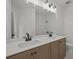 Bathroom featuring double sinks, sleek cabinetry, large mirror and modern lighting fixtures at 4445 Beechnut Circle, Cumming, GA 30028