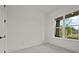 Bright, carpeted bedroom with a large window overlooking the landscaped backyard at 4445 Beechnut Circle, Cumming, GA 30028