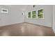Bright bedroom showcases hardwood flooring, vaulted ceilings, and ample natural light from multiple windows at 4445 Beechnut Circle, Cumming, GA 30028