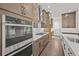 Modern kitchen design featuring stainless steel appliances, custom cabinets and range hood at 4445 Beechnut Circle, Cumming, GA 30028