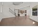 Open-concept living area with hardwood floors, a staircase, and views of the modern kitchen at 4445 Beechnut Circle, Cumming, GA 30028