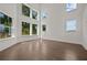 Bright and airy living room with hardwood floors and large windows showcasing beautiful outdoor views at 4445 Beechnut Circle, Cumming, GA 30028