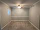 A versatile room showcasing neutral paint, crown molding, and a ceiling fan with ample natural light at 1612 Huntingdon, Atlanta, GA 30350