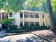 Apartment building featuring multiple windows, complemented by mature trees and greenery at 1612 Huntingdon, Atlanta, GA 30350
