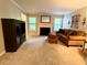 Inviting living room with a cozy fireplace, neutral carpet, and a comfortable brown sofa at 1612 Huntingdon, Atlanta, GA 30350