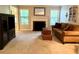 Inviting living room with a cozy fireplace, neutral carpet, and a comfortable brown sofa at 1612 Huntingdon, Atlanta, GA 30350