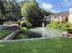 Scenic pond with fountain and lush greenery adding to the serene community setting at 1612 Huntingdon, Atlanta, GA 30350