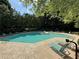 Community pool surrounded by many lounge chairs with plenty of lush greenery at 1612 Huntingdon, Atlanta, GA 30350
