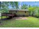 An expansive backyard featuring a spacious deck and lush green lawn, perfect for outdoor activities and relaxation at 2242 Cherokee Valley Cir, Lithonia, GA 30058