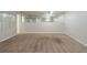 Spacious basement featuring neutral walls, plush carpet flooring, and a mirrored accent wall at 2242 Cherokee Valley Cir, Lithonia, GA 30058