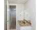 Bathroom with vanity sink and mirror, adjacent to finished basement space at 2242 Cherokee Valley Cir, Lithonia, GA 30058