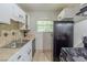 Functional kitchen with tile backsplash, window view, and modern appliances at 2242 Cherokee Valley Cir, Lithonia, GA 30058