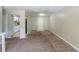 Open living area leading to the kitchen with carpeted flooring, and neutral paint at 2242 Cherokee Valley Cir, Lithonia, GA 30058