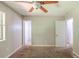 A spacious main bedroom with a ceiling fan, a window and access to a bathroom at 2242 Cherokee Valley Cir, Lithonia, GA 30058