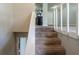 Carpeted staircase leading to the upper level, showcasing neutral tones and natural lighting at 2242 Cherokee Valley Cir, Lithonia, GA 30058