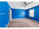 Spacious bedroom featuring carpet flooring, window and bright blue walls at 573 Hambrick Sq, Stone Mountain, GA 30083