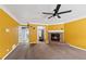Spacious living room with a brick fireplace, ceiling fan, and carpet flooring at 573 Hambrick Sq, Stone Mountain, GA 30083