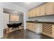 Elegant bar area featuring custom cabinets, granite counters, a wine rack, and stylish tile flooring at 1292 Lenox Park Ne Blvd, Brookhaven, GA 30319