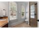 Well-lit bathroom featuring a shower, toilet, and sink, with an exterior view through the window at 1292 Lenox Park Ne Blvd, Brookhaven, GA 30319