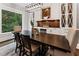 Dining room with a modern light fixture, a rustic wood table, and decorative built-in cabinets at 1292 Lenox Park Ne Blvd, Brookhaven, GA 30319