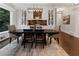 Elegant dining room with a large table, stylish chairs, and built-in cabinets at 1292 Lenox Park Ne Blvd, Brookhaven, GA 30319
