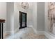 Grand foyer showcasing marble floors, elegant trim, neutral paint, and an ornate iron-and-glass front door at 1292 Lenox Park Ne Blvd, Brookhaven, GA 30319