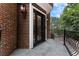 Elegant front door with decorative wrought iron, stylish sconces, brick exterior, and stone walkway at 1292 Lenox Park Ne Blvd, Brookhaven, GA 30319
