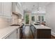Well-lit kitchen with stainless steel appliances, custom countertops, and access to a backyard terrace at 1292 Lenox Park Ne Blvd, Brookhaven, GA 30319