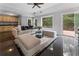 Spacious living room with a wet bar, hardwood floors, a sectional sofa and an outside view at 1292 Lenox Park Ne Blvd, Brookhaven, GA 30319
