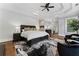 A large primary bedroom featuring dark wood furniture, hardwood floors, and a ceiling fan at 1292 Lenox Park Ne Blvd, Brookhaven, GA 30319