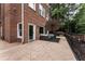 Spacious patio with outdoor seating and a view of the landscaped backyard of a brick house at 1292 Lenox Park Ne Blvd, Brookhaven, GA 30319