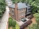 Stunning aerial view of a brick home showcasing a multi-tiered deck and outdoor living space, perfect for entertaining at 1292 Lenox Park Ne Blvd, Brookhaven, GA 30319