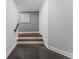 View of the staircase featuring hardwood stairs and flooring, contrasted by neutral colored walls at 1292 Lenox Park Ne Blvd, Brookhaven, GA 30319