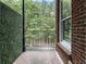Brick Terrace featuring a black iron railing and a wall covered in greenery at 1292 Lenox Park Ne Blvd, Brookhaven, GA 30319